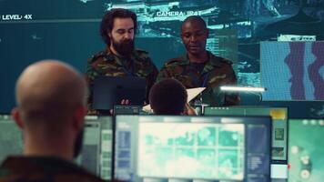 Crew captain and general briefing the troops in military headquarters command center, operating with a big screen to follow CCTV reconnaissance system. Soldiers collecting data. Camera A. video