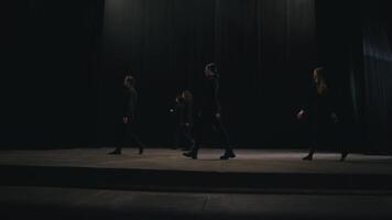 Side view of five confident student actors in the theater walking on stage during their rehearsal and preparation for classes at the theater university video