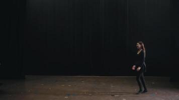 Young students and actors at the theater university go on stage in black suits and greet and hug. A group of actors go on stage and greet each other before the start of a rehearsal and class at the video