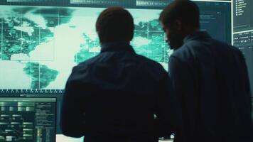 Cyber security team conducting cyber surveillance in a governmental control room. Experts group hacking activities, malware protection and data breach prevention in high tech agency. Camera A. video