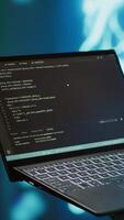Vertical Engineer using notebook to maintenance artificial intelligence neural networks. Close up shot of IT expert using AI system aiding in processing and transmitting information, camera A video