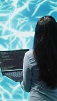 Vertical Computer scientist working on laptop, programming artificial intelligence computing simulating human brain. Woman using notebook, developing AI machine learning algorithms, camera A video