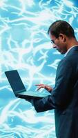 Vertical System administrator working on laptop, programming artificial intelligence computing simulating human brain. Man in workspace using notebook, building AI machine learning algorithms, camera A video