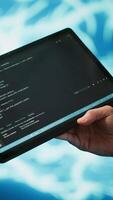 Vertical Programmer using tablet to maintenance artificial intelligence neural networks. Close up shot of computer scientist using AI system aiding in processing and transmitting information, camera A video