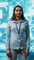 Vertical Portrait of smiling technician running artificial intelligence programming scripts. Joyful admin working in IT department tasked with AI applications development, camera A video