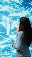 Vertical Engineer wearing VR headset and coworker working with artificial intelligence neural networks. Colleagues using virtual reality technology and AI system in high tech workspace, camera A video