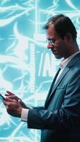 Vertical IT specialist coding on tablet, programming artificial intelligence computing simulating human brain. Programmer using technology gear to build AI machine learning algorithms, camera A video