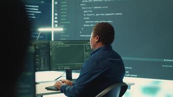 Cyber defense team working in a governmental security operations center. Experts ensuring cybercrime prevention and data breach protection, examining information on a big screen. Camera A. video