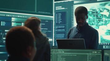 Governmental hackers performing a cyber attack simulation after studying the national database servers. Experts working on IT security, data breach prevention against ransomware. Camera A. video