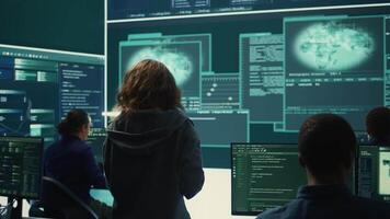 Hackers team engaging in governmental espionage and using phishing techniques for illegal access to data, working on national security breach. Spyware agency gains access on a big screen. Camera B. video