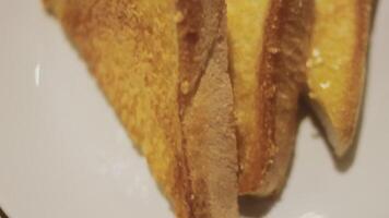 Fresh crusty buttered rye bread slices sprinkled with chopped parsley and garnished with a butter curl video