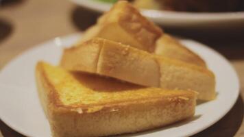 Fresh crusty buttered rye bread slices sprinkled with chopped parsley and garnished with a butter curl video