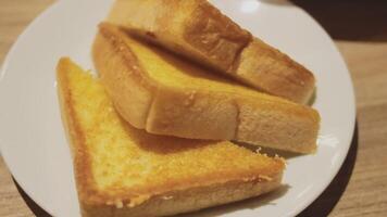 Fresh crusty buttered rye bread slices sprinkled with chopped parsley and garnished with a butter curl video