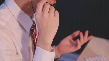 Where would we be without loyal customers like you. Shot of a young man using a headset and computer in a modern office. video
