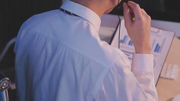 Where would we be without loyal customers like you. Shot of a young man using a headset and computer in a modern office. video