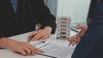 Sale representative offer house purchase contract to buy a house or apartment or discussing about loans and interest rates video