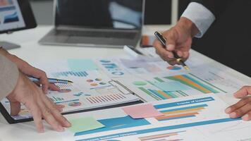 Business meeting time,business account managers crew working with new startup project,report analysis cost graph on desk at meeting room. video