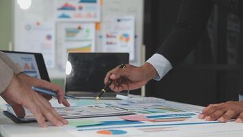 Business meeting time,business account managers crew working with new startup project,report analysis cost graph on desk at meeting room. video