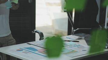 Business meeting time,business account managers crew working with new startup project,report analysis cost graph on desk at meeting room. video