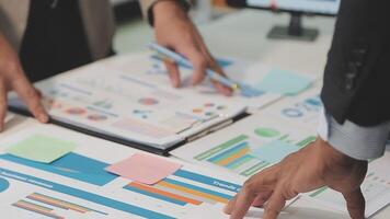 Business meeting time,business account managers crew working with new startup project,report analysis cost graph on desk at meeting room. video