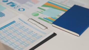 Business meeting time,business account managers crew working with new startup project,report analysis cost graph on desk at meeting room. video
