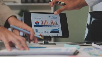 Business meeting time,business account managers crew working with new startup project,report analysis cost graph on desk at meeting room. video