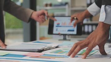 Business meeting time,business account managers crew working with new startup project,report analysis cost graph on desk at meeting room. video