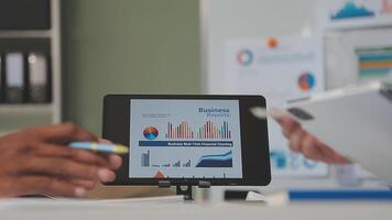Business meeting time,business account managers crew working with new startup project,report analysis cost graph on desk at meeting room. video