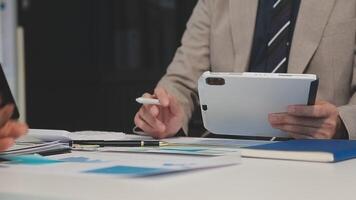 Business meeting time,business account managers crew working with new startup project,report analysis cost graph on desk at meeting room. video