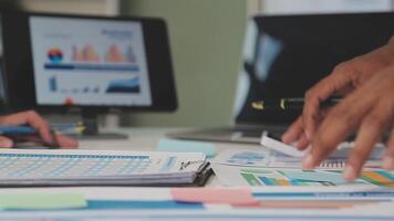 Business meeting time,business account managers crew working with new startup project,report analysis cost graph on desk at meeting room. video