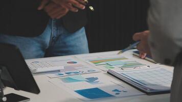 Business meeting time,business account managers crew working with new startup project,report analysis cost graph on desk at meeting room. video