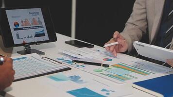 Business meeting time,business account managers crew working with new startup project,report analysis cost graph on desk at meeting room. video