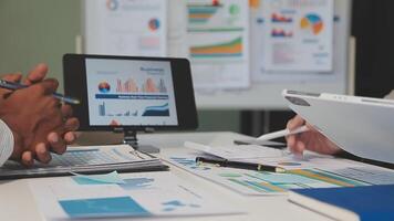 Business meeting time,business account managers crew working with new startup project,report analysis cost graph on desk at meeting room. video