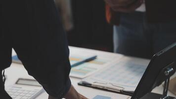 Business meeting time,business account managers crew working with new startup project,report analysis cost graph on desk at meeting room. video