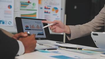 Business meeting time,business account managers crew working with new startup project,report analysis cost graph on desk at meeting room. video