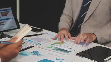 Business meeting time,business account managers crew working with new startup project,report analysis cost graph on desk at meeting room. video