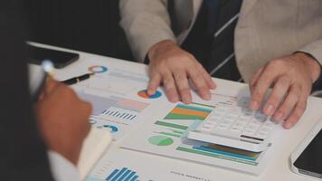 Business meeting time,business account managers crew working with new startup project,report analysis cost graph on desk at meeting room. video