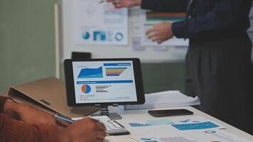 Business meeting time,business account managers crew working with new startup project,report analysis cost graph on desk at meeting room. video
