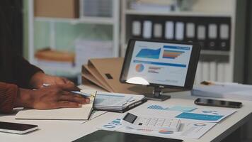Business meeting time,business account managers crew working with new startup project,report analysis cost graph on desk at meeting room. video