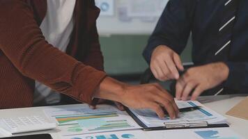 Business meeting time,business account managers crew working with new startup project,report analysis cost graph on desk at meeting room. video