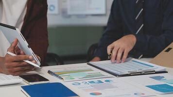 Business meeting time,business account managers crew working with new startup project,report analysis cost graph on desk at meeting room. video