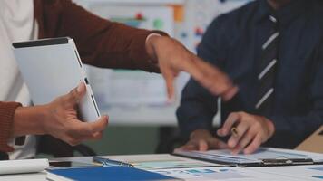 Business meeting time,business account managers crew working with new startup project,report analysis cost graph on desk at meeting room. video