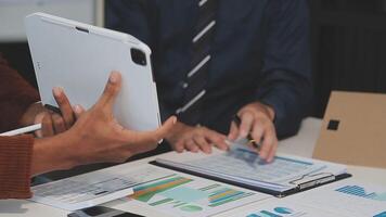 Business meeting time,business account managers crew working with new startup project,report analysis cost graph on desk at meeting room. video