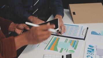 Business meeting time,business account managers crew working with new startup project,report analysis cost graph on desk at meeting room. video
