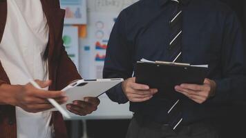 Business meeting time,business account managers crew working with new startup project,report analysis cost graph on desk at meeting room. video