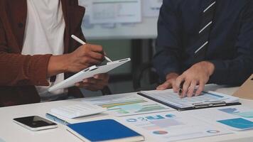 Business meeting time,business account managers crew working with new startup project,report analysis cost graph on desk at meeting room. video