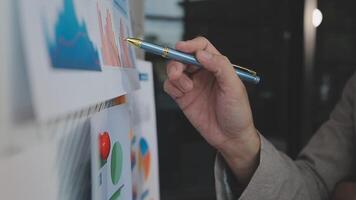 Business meeting time,business account managers crew working with new startup project,report analysis cost graph on desk at meeting room. video