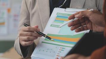 Business meeting time,business account managers crew working with new startup project,report analysis cost graph on desk at meeting room. video
