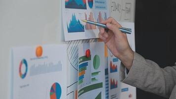 Business meeting time,business account managers crew working with new startup project,report analysis cost graph on desk at meeting room. video