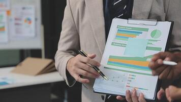 Business meeting time,business account managers crew working with new startup project,report analysis cost graph on desk at meeting room. video
